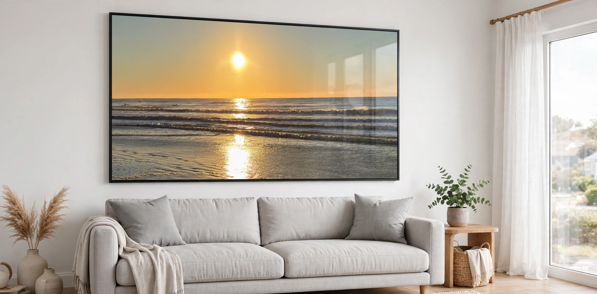 Panoramic Folly Beach artwork shown as a large metal print above a couch in a bright coastal living room